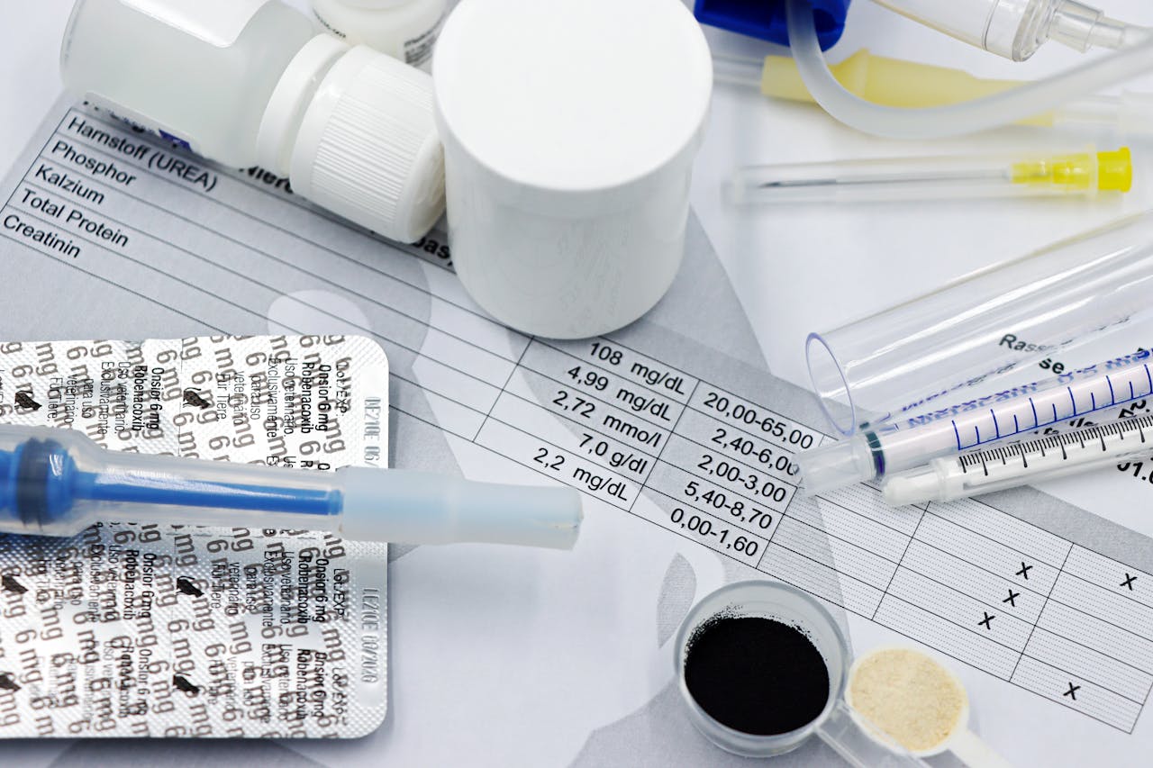 heros-img Vet supplies like syringes and medicines on blood test reports, suggesting medical care theme.